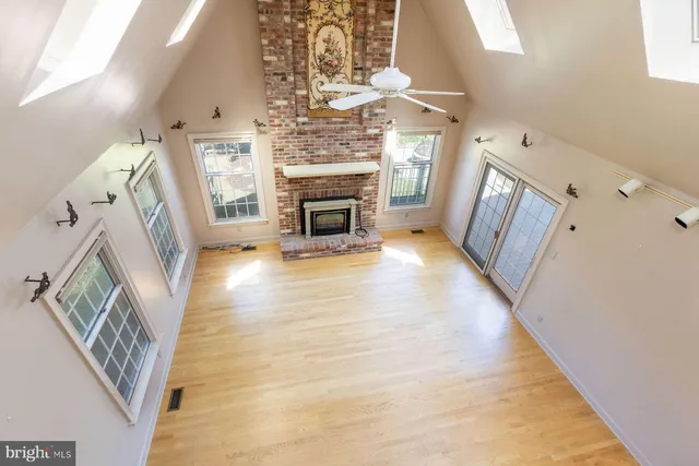 a spacious bathroom with a granite countertop sink a mirror and a bathtub