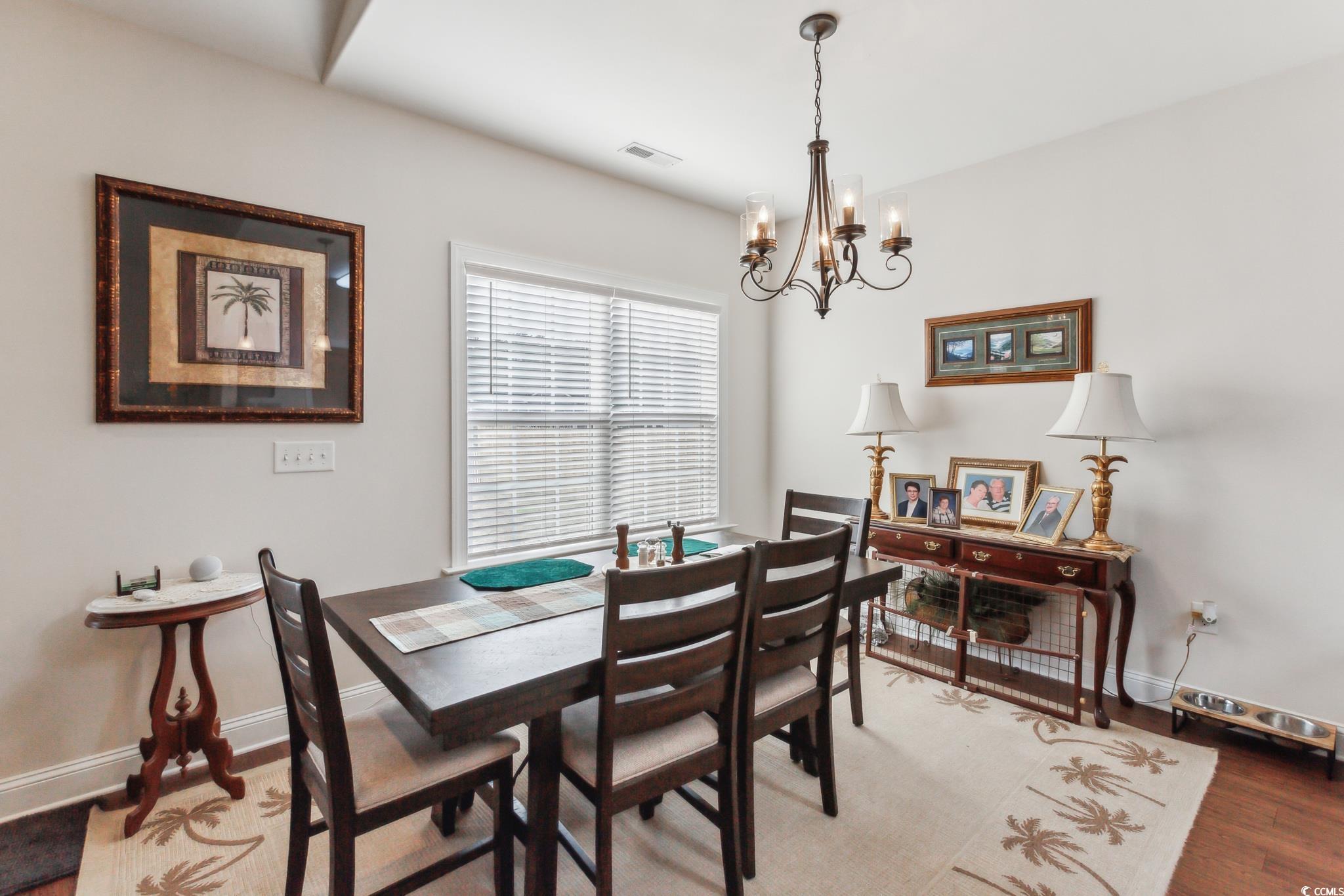 607 Garden Avenue Georgetown, SC 29440 - Photo 12 of 35 Dining area with an inviting chandelier and wood-type flooring