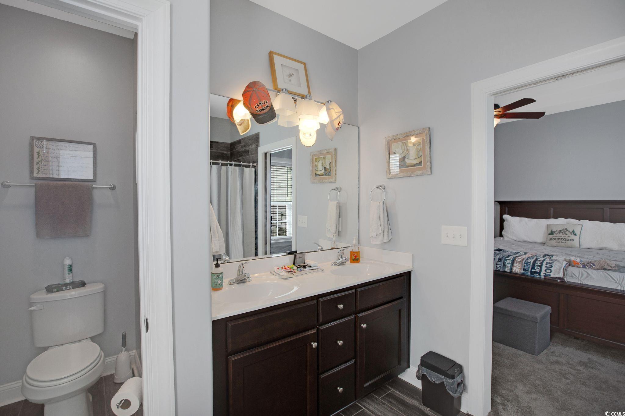 607 Garden Avenue Georgetown, SC 29440 - Photo 19 of 35 Bathroom with vanity, a shower with curtain, toilet, and ceiling fan