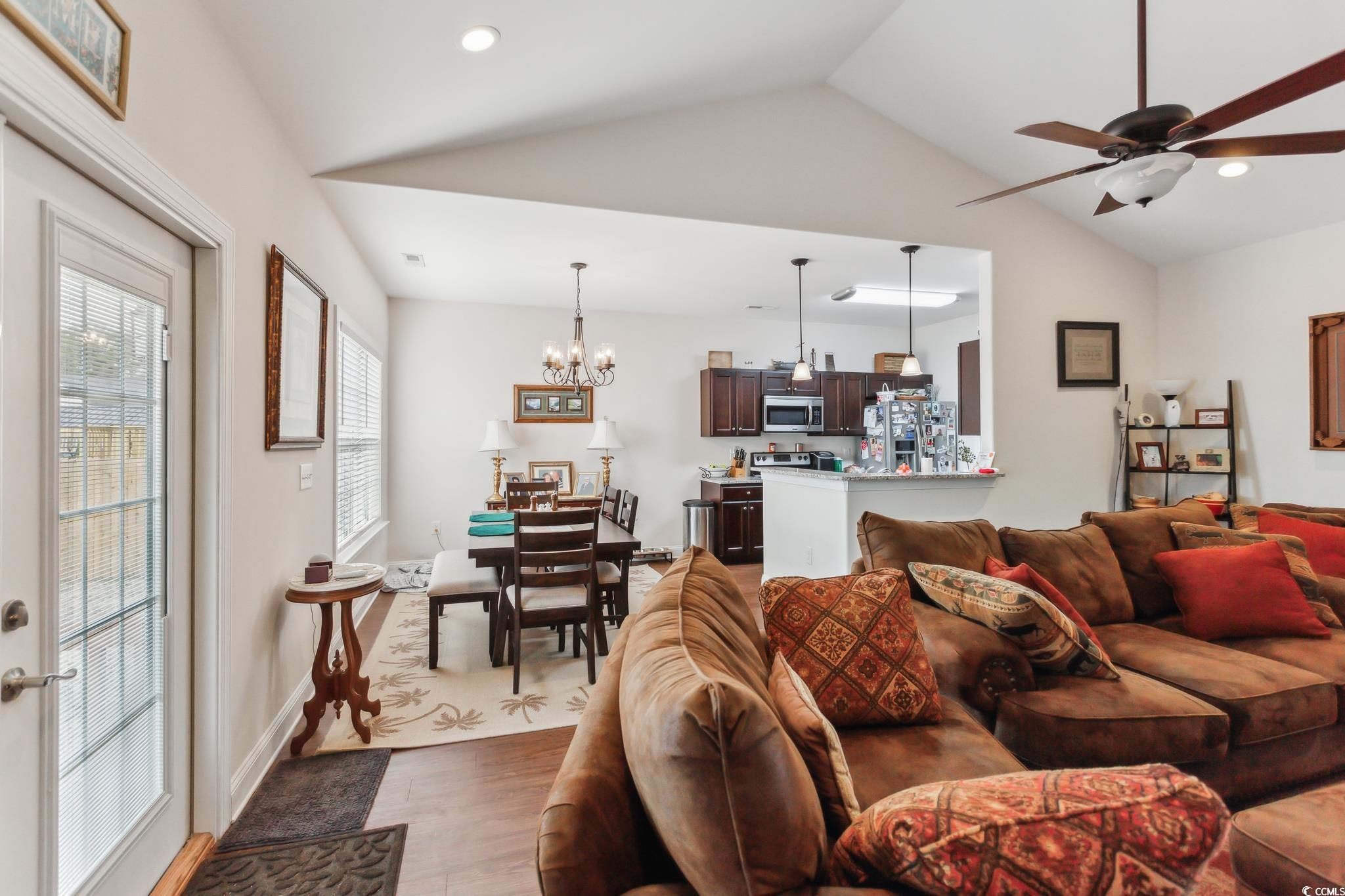 607 Garden Avenue Georgetown, SC 29440 - Photo 7 of 35 Living room with hardwood / wood-style floors, ceiling fan with notable chandelier, and vaulted ceiling
