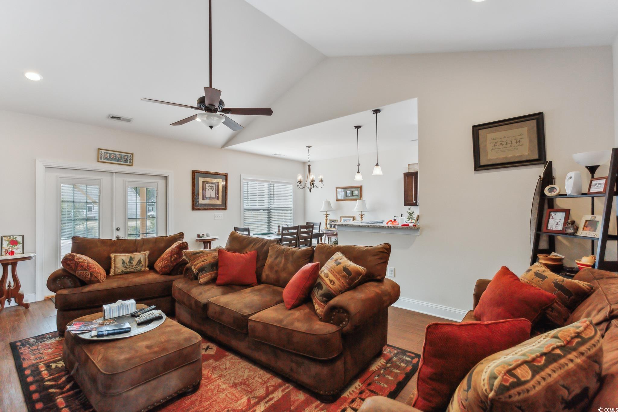 607 Garden Avenue Georgetown, SC 29440 - Photo 8 of 35 Living room featuring ceiling fan with notable chandelier, wood-type flooring, french doors, and vaulted ceiling