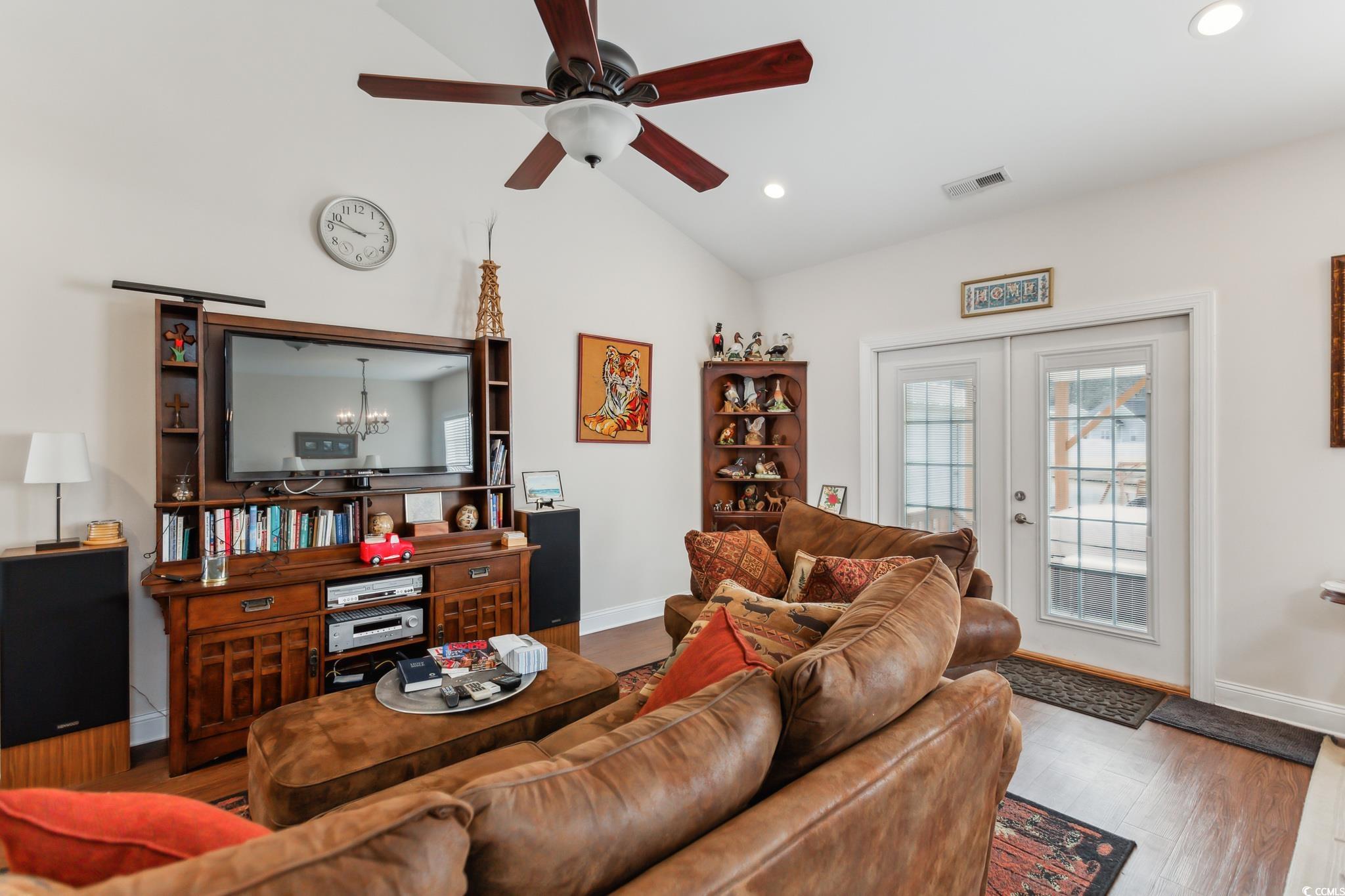 607 Garden Avenue Georgetown, SC 29440 - Photo 10 of 35 Living room with hardwood / wood-style flooring, lofted ceiling, ceiling fan with notable chandelier, and french doors