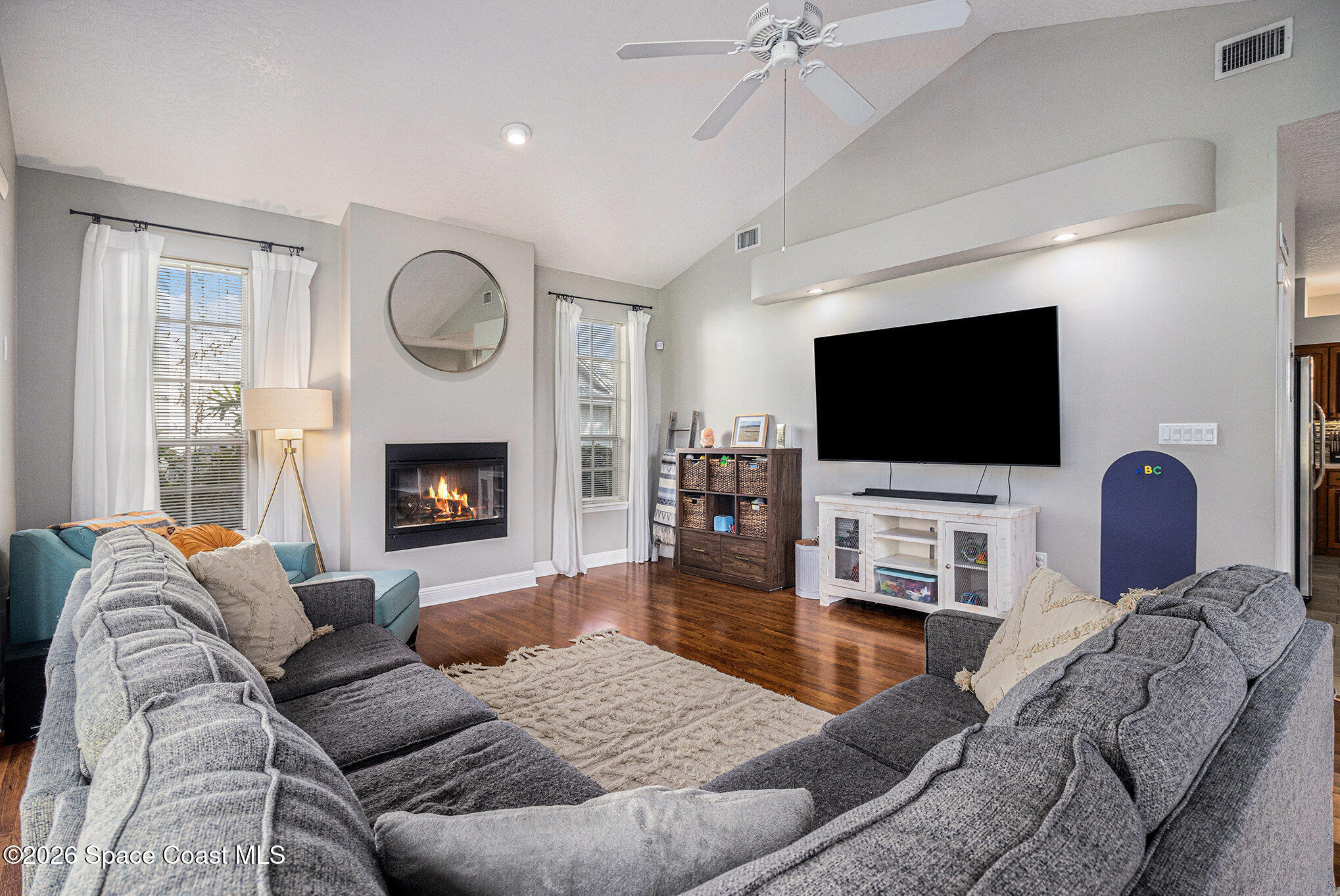 4115 Savannahs Trail Merritt Island, FL 32953 - Photo 13 of 42 a living room with furniture a flat screen tv and a fireplace
