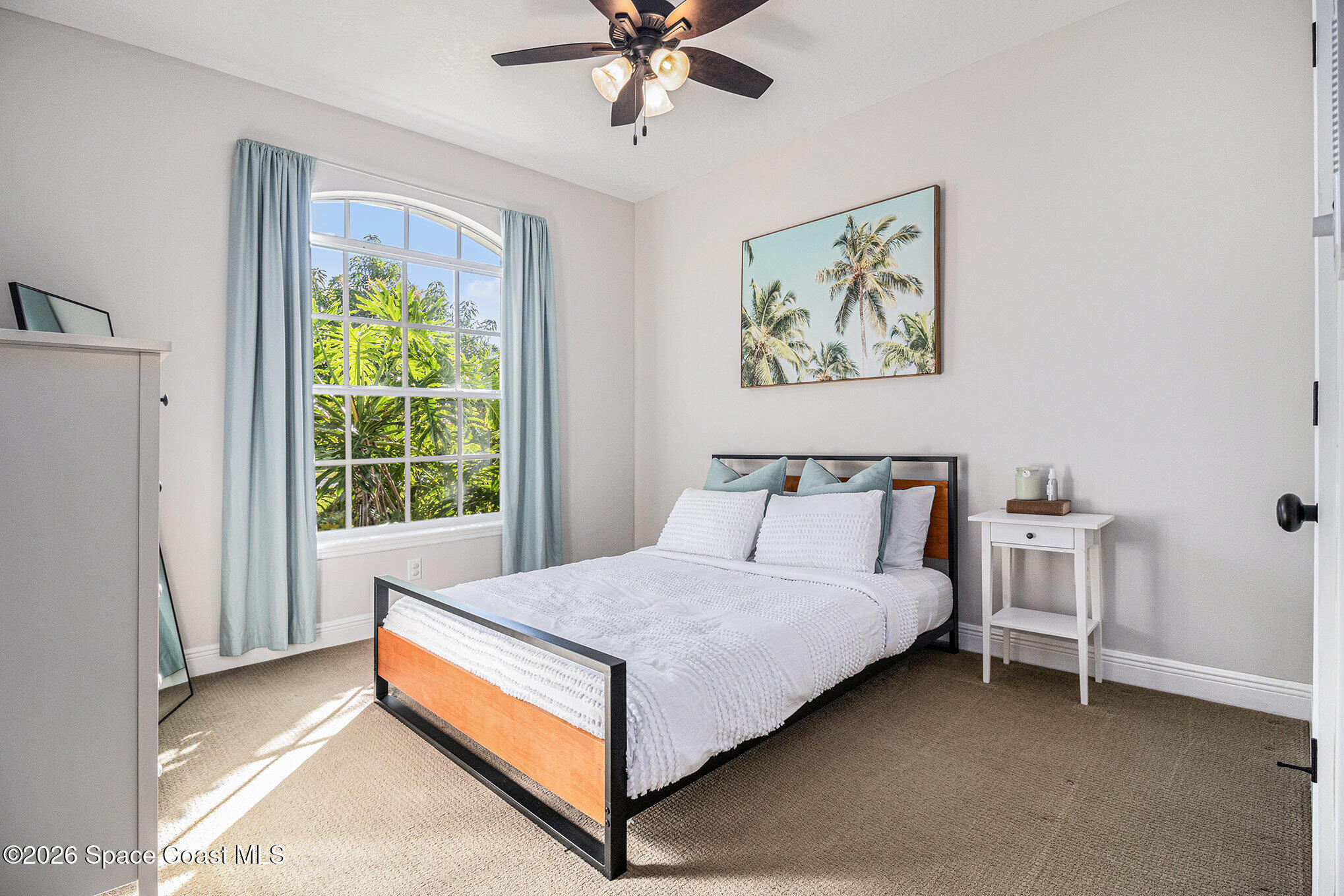 4115 Savannahs Trail Merritt Island, FL 32953 - Photo 15 of 42 a bed sitting in a bedroom next to a window
