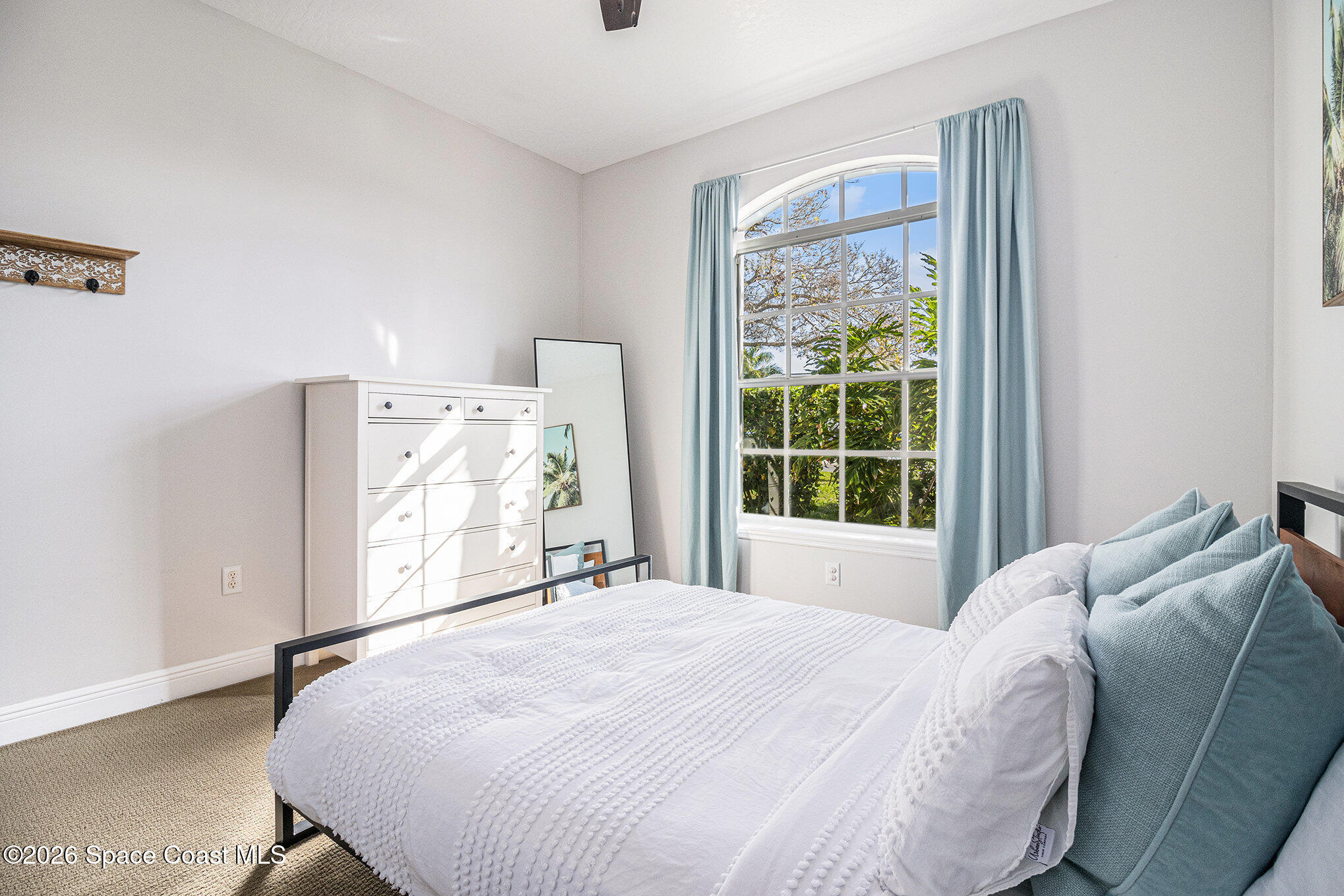 4115 Savannahs Trail Merritt Island, FL 32953 - Photo 16 of 42 a bed sitting in a bedroom next to a window