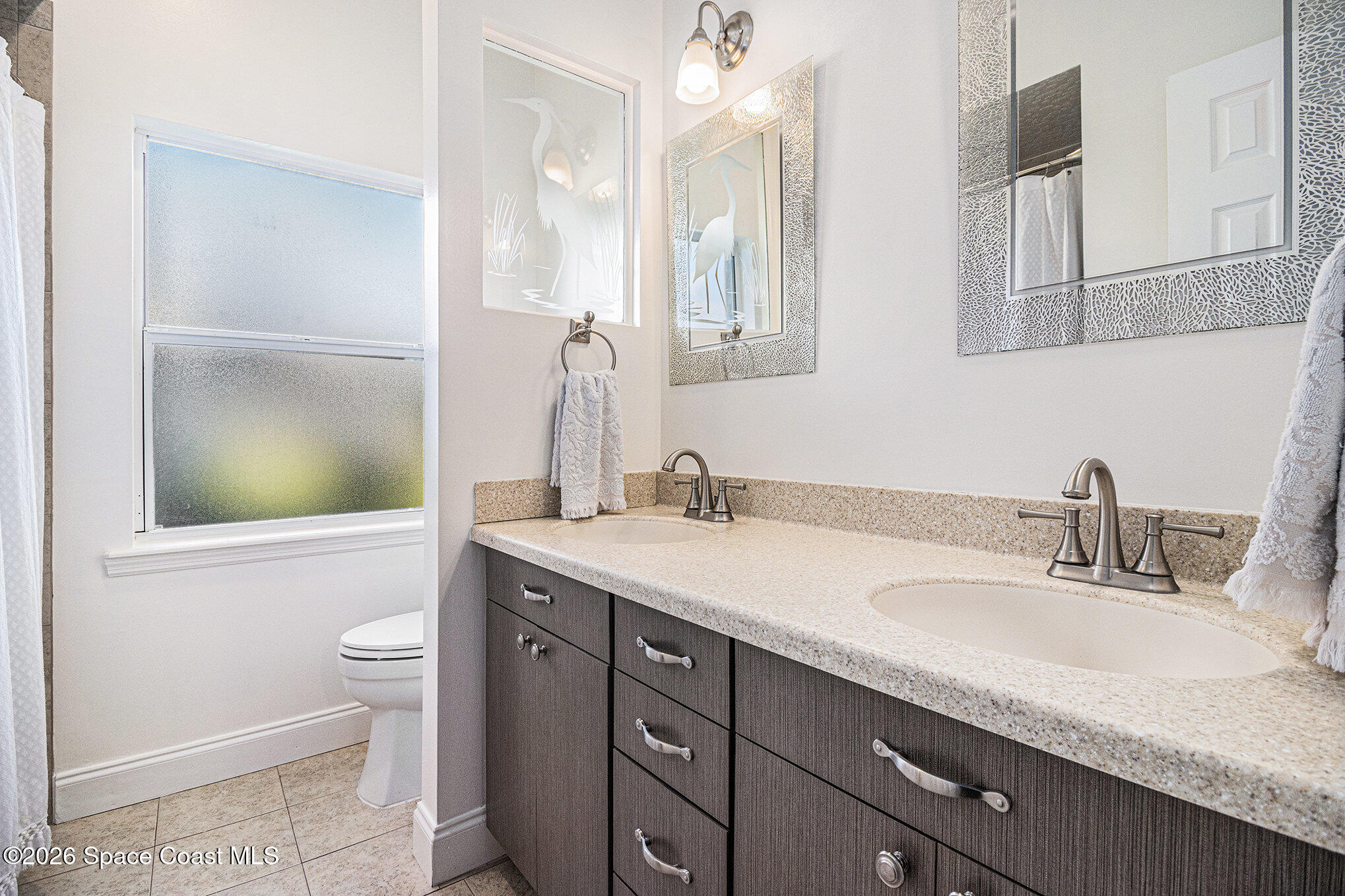 4115 Savannahs Trail Merritt Island, FL 32953 - Photo 20 of 42 a bathroom with a granite countertop sink a toilet and a mirror