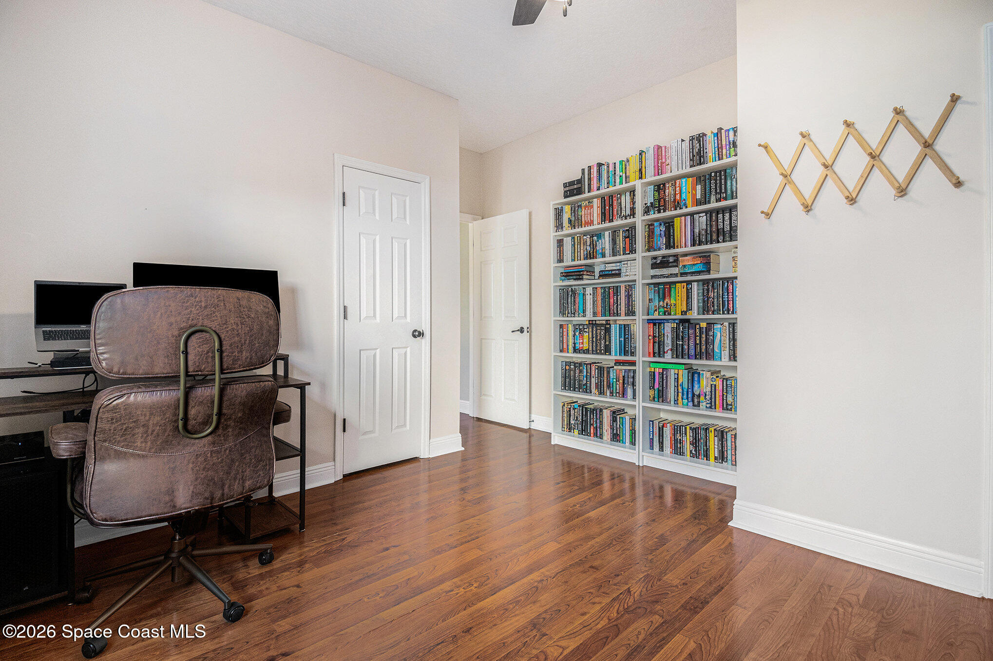 4115 Savannahs Trail Merritt Island, FL 32953 - Photo 21 of 42 a living room with furniture and a book shelf