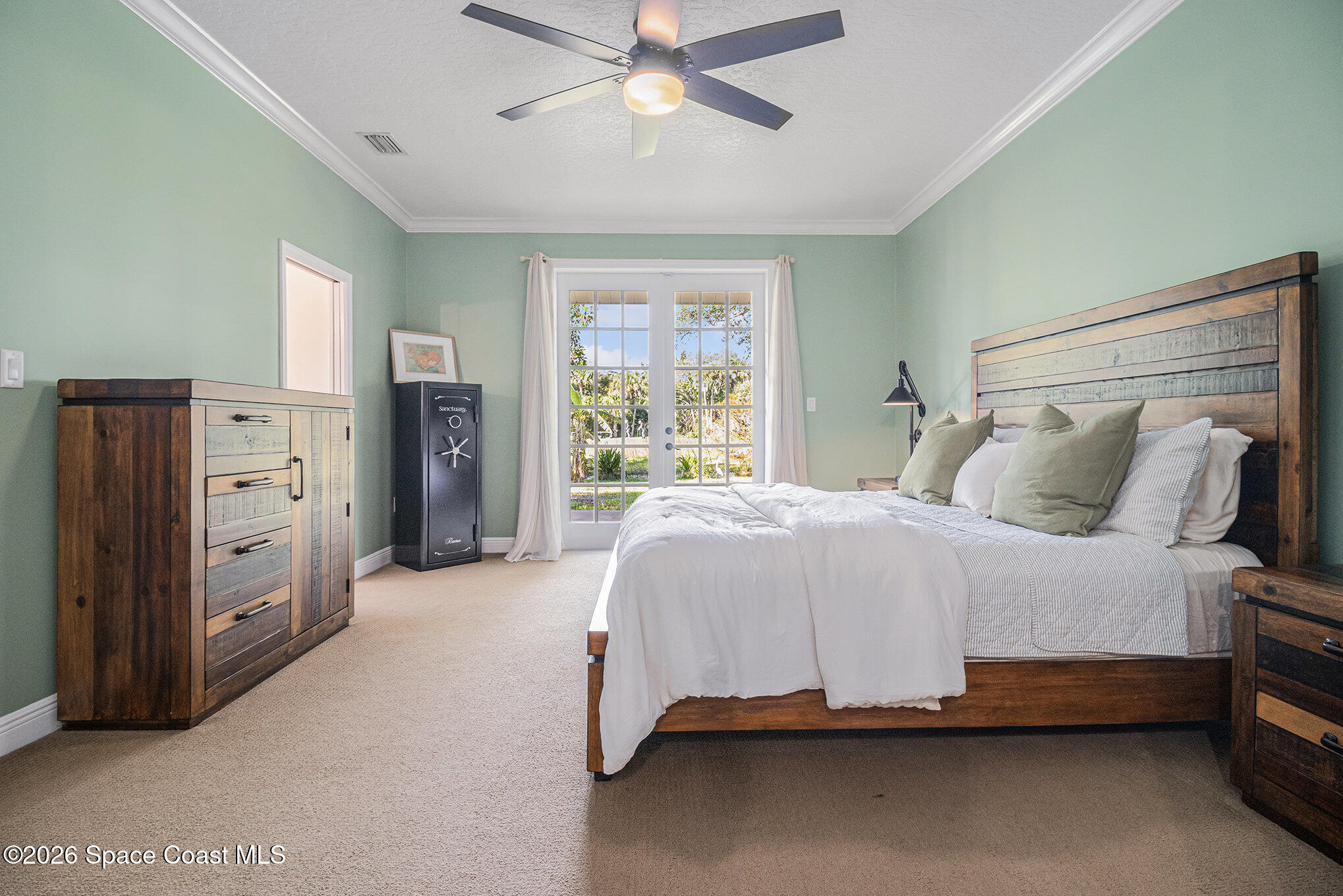 4115 Savannahs Trail Merritt Island, FL 32953 - Photo 25 of 42 a spacious bedroom with a bed and a chandelier