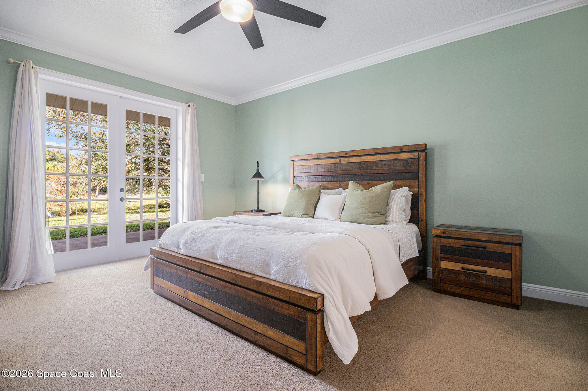 4115 Savannahs Trail Merritt Island, FL 32953 - Photo 26 of 42 a spacious bedroom with a bed and a large window