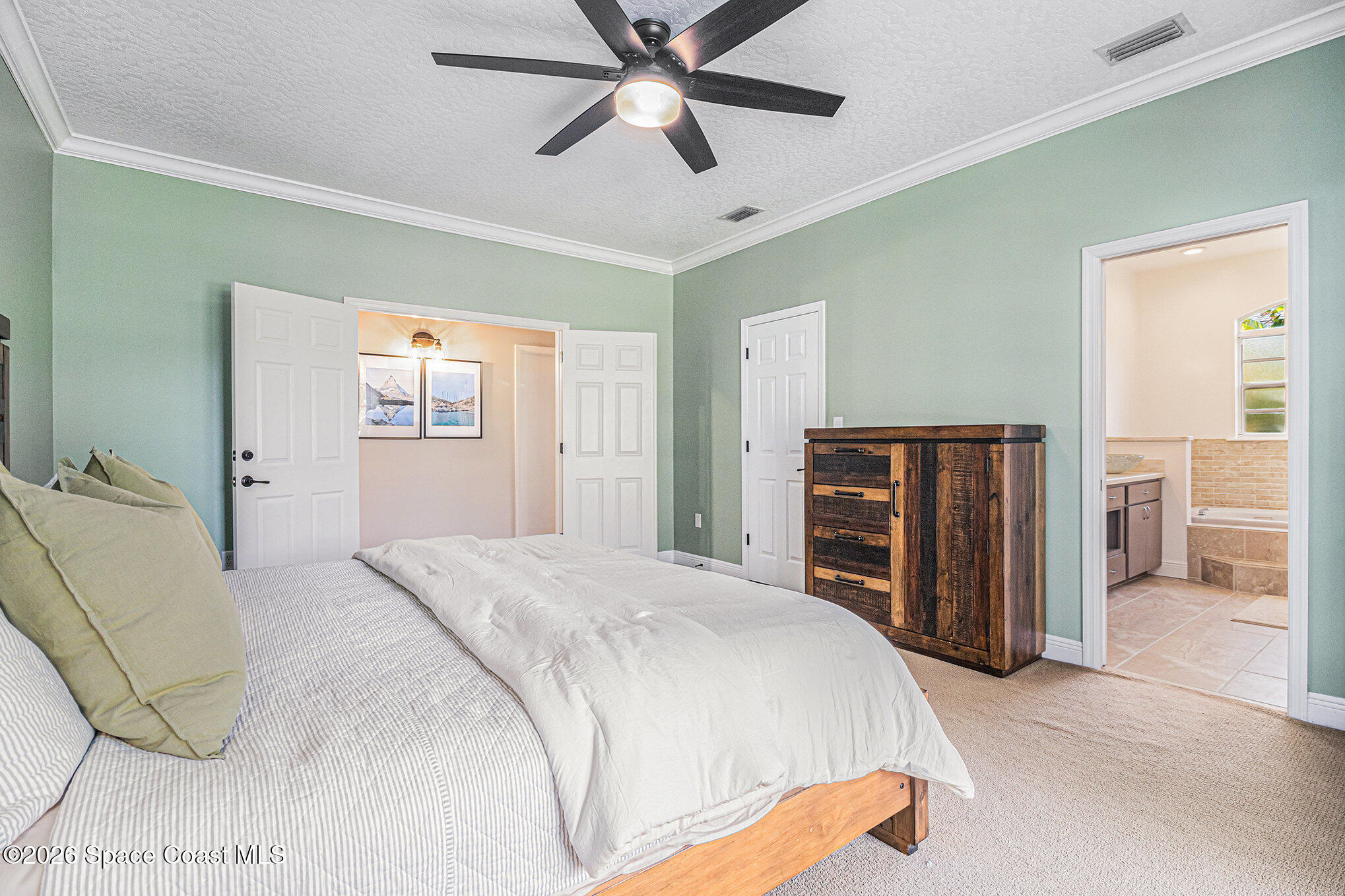 4115 Savannahs Trail Merritt Island, FL 32953 - Photo 29 of 42 a bedroom with a bed and dresser