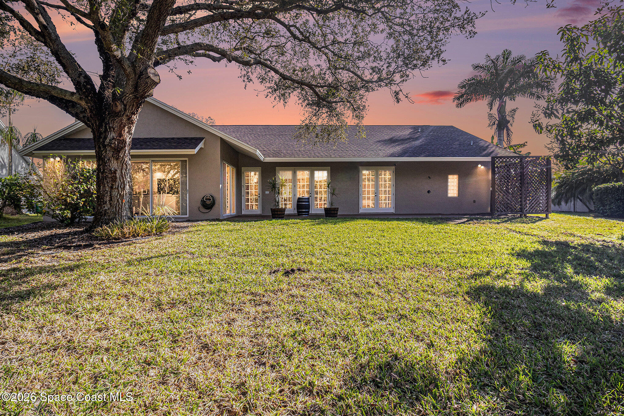 4115 Savannahs Trail Merritt Island, FL 32953 - Photo 33 of 42 a large house with a large tree in front of it
