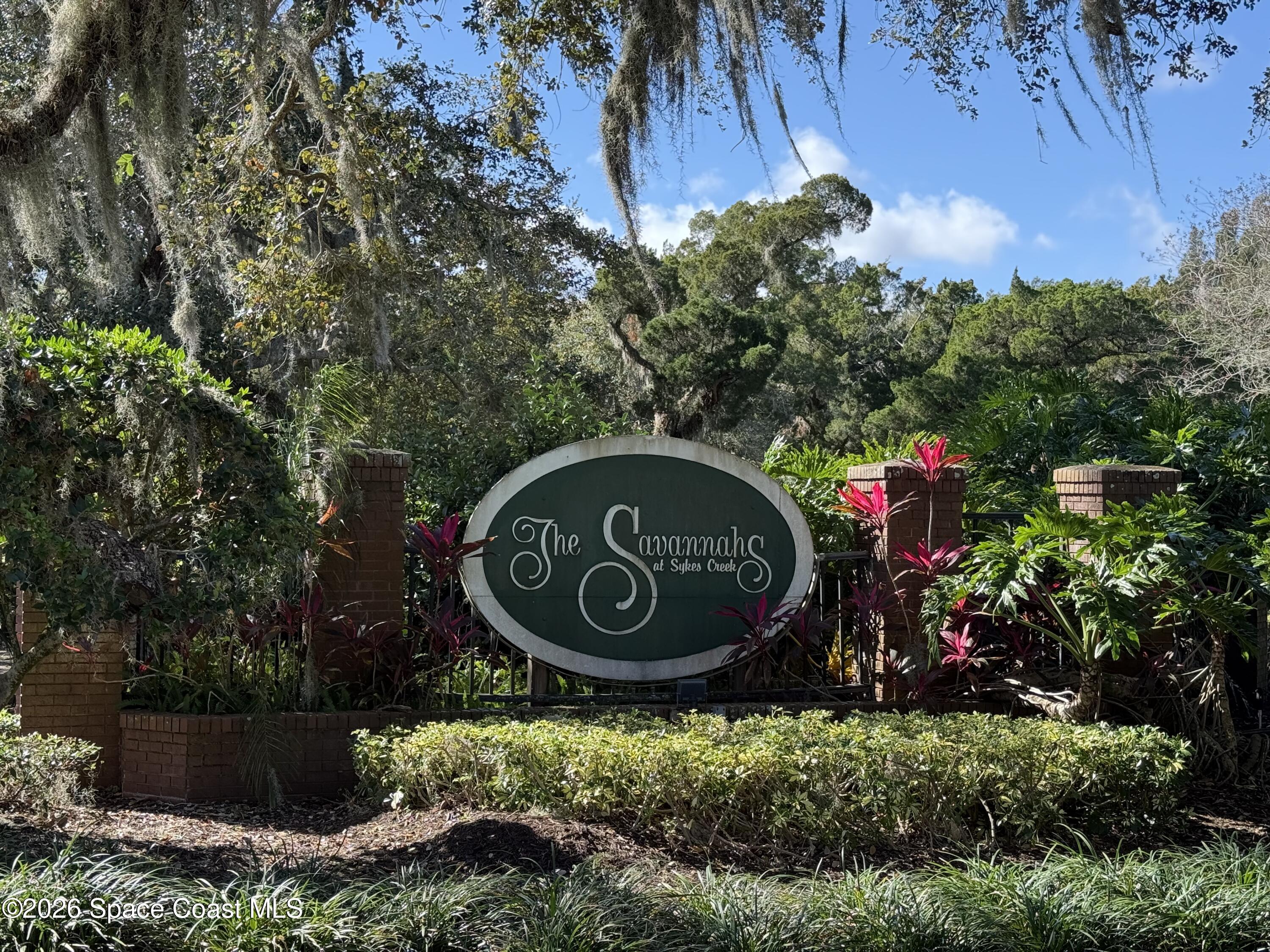 4115 Savannahs Trail Merritt Island, FL 32953 - Photo 42 of 42 a sign that is sitting in front of flowers