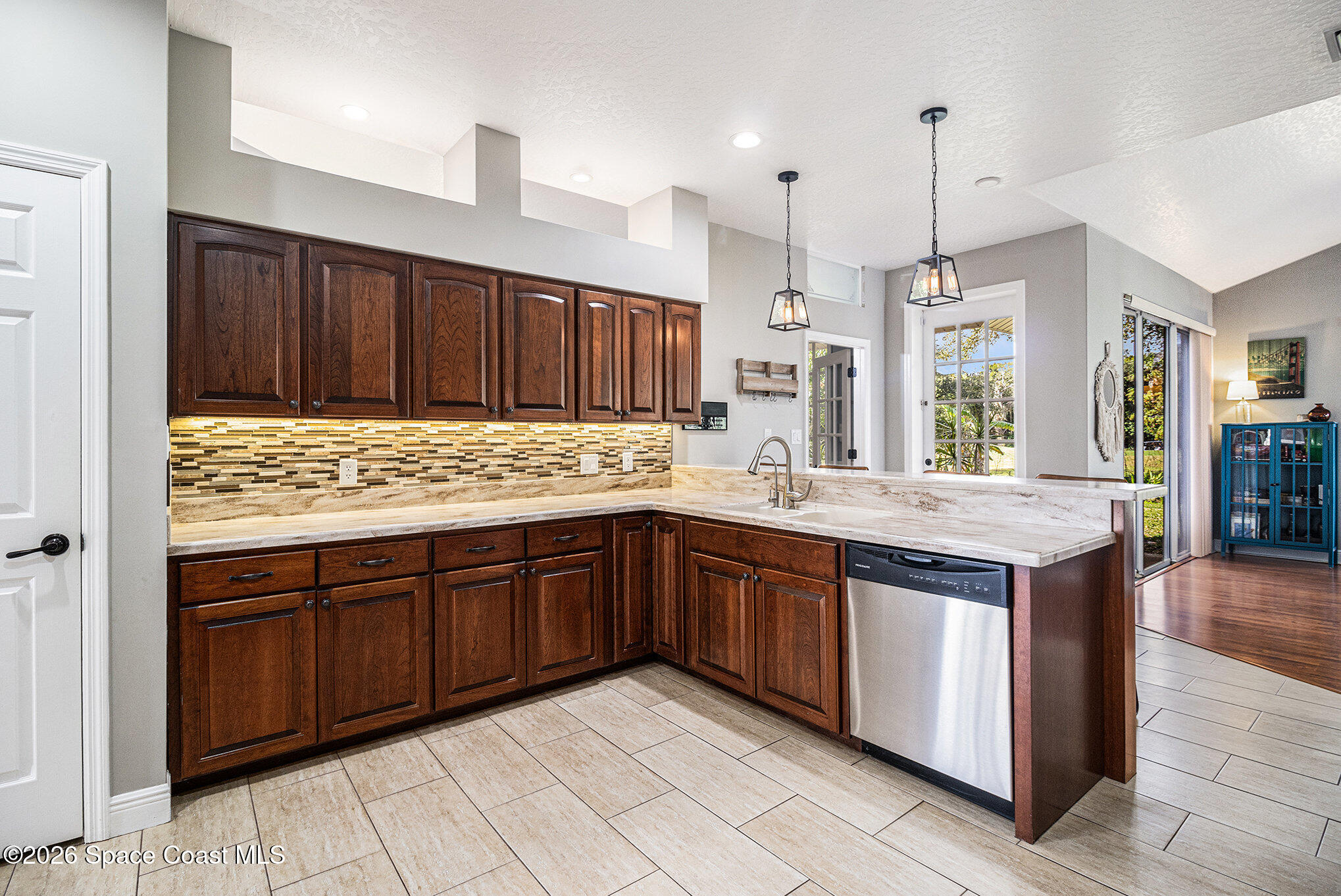 4115 Savannahs Trail Merritt Island, FL 32953 - Photo 9 of 42 a kitchen with stainless steel appliances granite countertop a stove a sink dishwasher and a wooden cabinets