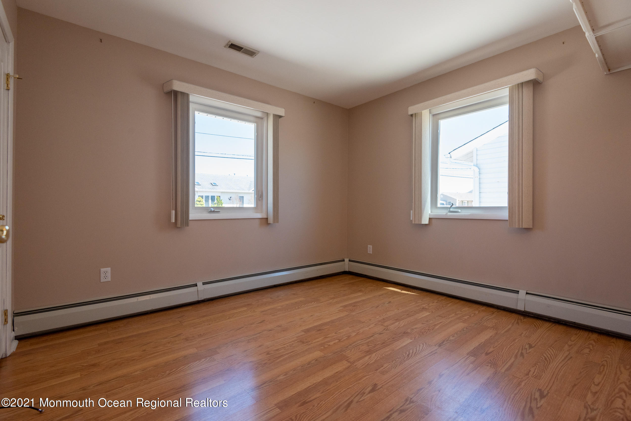 204 Maplewood Road Barnegat, NJ 08005 - Photo 21 of 26 an empty room with wooden floor and windows