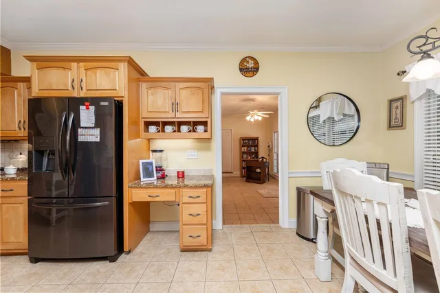 a kitchen with stainless steel appliances granite countertop a refrigerator and a stove