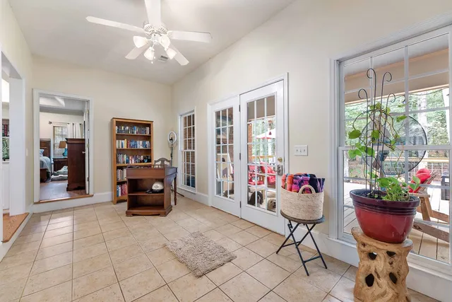 a living room with furniture and a potted plant