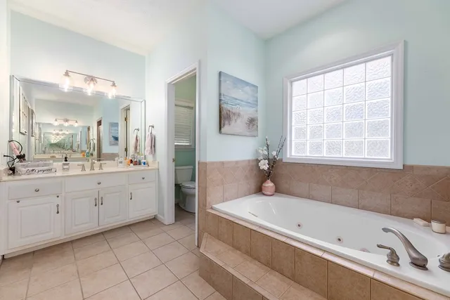 a bathroom with a bathtub sink and mirror