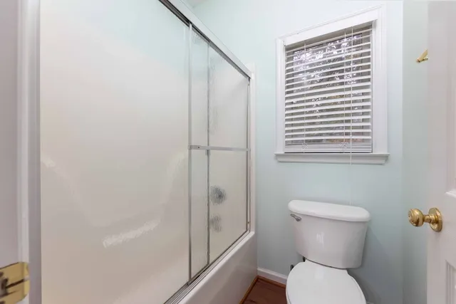 a bedroom with bed and a chandelier