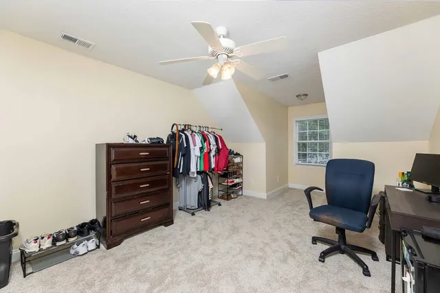 a bathroom with a sink a toilet and shower curtain