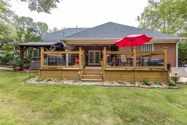 a view of a house with a yard patio and fire pit