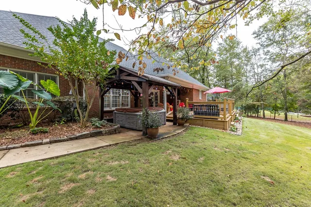 a roof deck with table and chairs under an umbrella