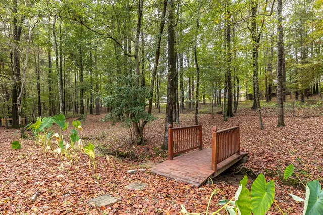 a view of a patio with table and chairs under an umbrella