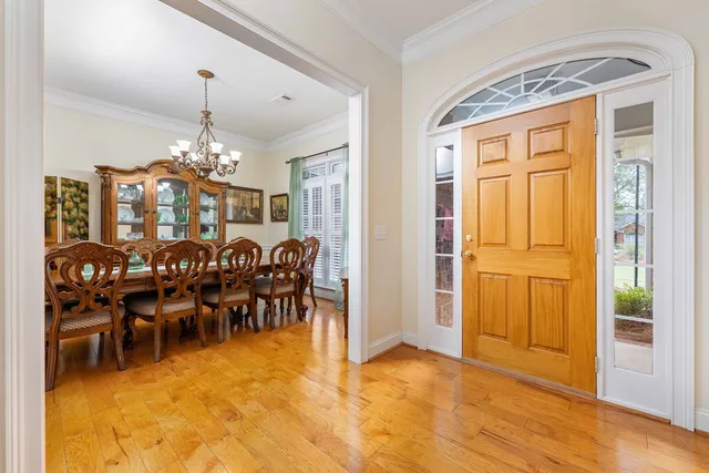 a view of a dining room with furniture and chandelier