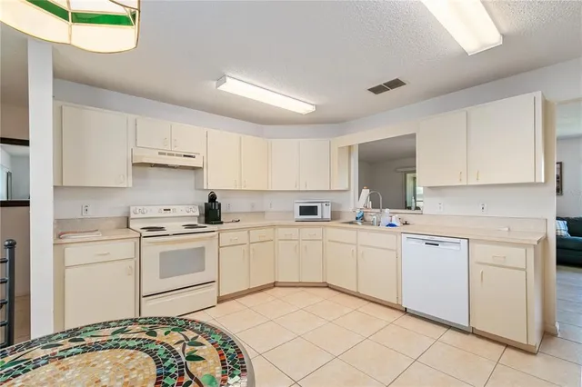 a kitchen with cabinets appliances and a sink