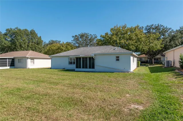 a front view of house with yard and trees