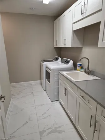 a kitchen with a sink and a stove top oven