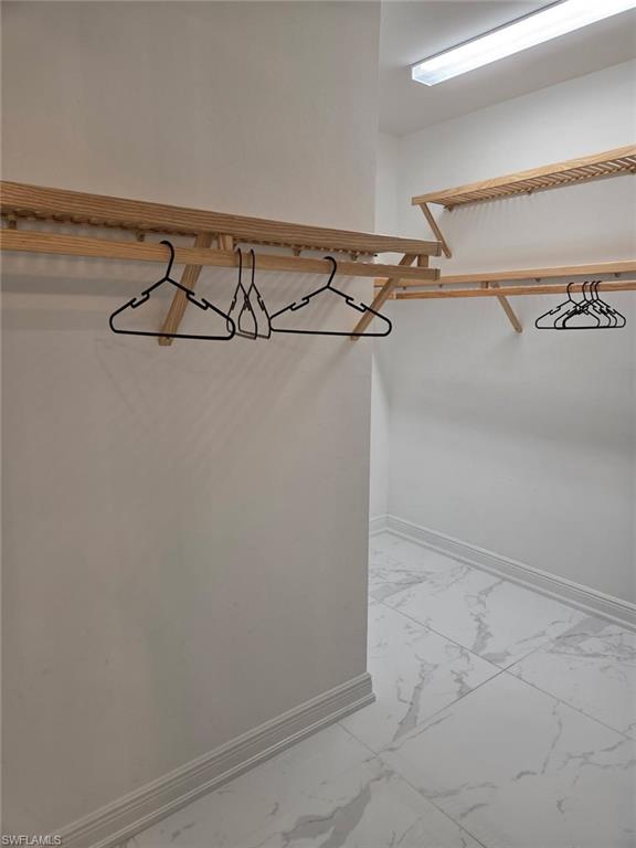 16370 Viansa Way, Unit 6 Naples, FL 34110 - Photo 21 of 27 Walk in closet featuring light marble finish floors