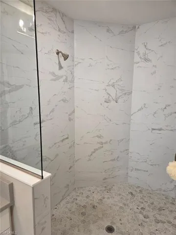 a living room with a rug and a ceiling fan