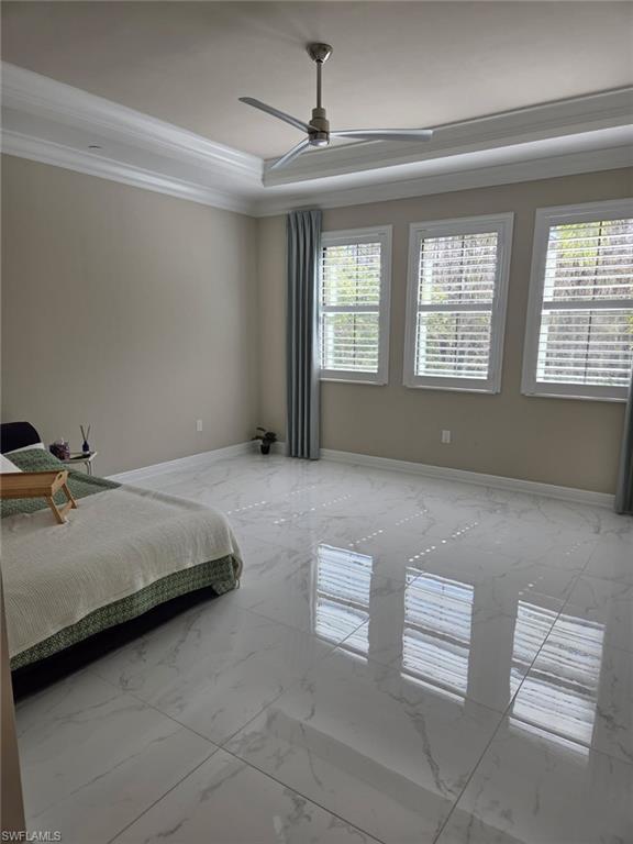 16370 Viansa Way, Unit 6 Naples, FL 34110 - Photo 26 of 27 Bedroom featuring marble finish flooring, a ceiling fan, and crown molding