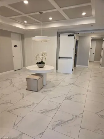 a view of a hallway with seating space