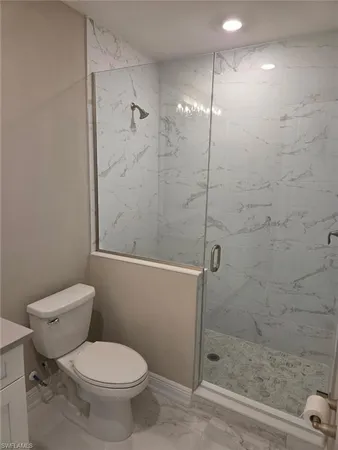 a bathroom with a toilet and a shower