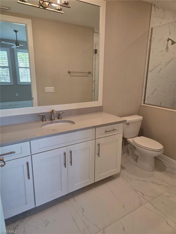 16370 Viansa Way, Unit 6 Naples, FL 34110 - Photo 6 of 27 Bathroom featuring light marble finish floors, vanity, a marble finish shower, and ceiling fan