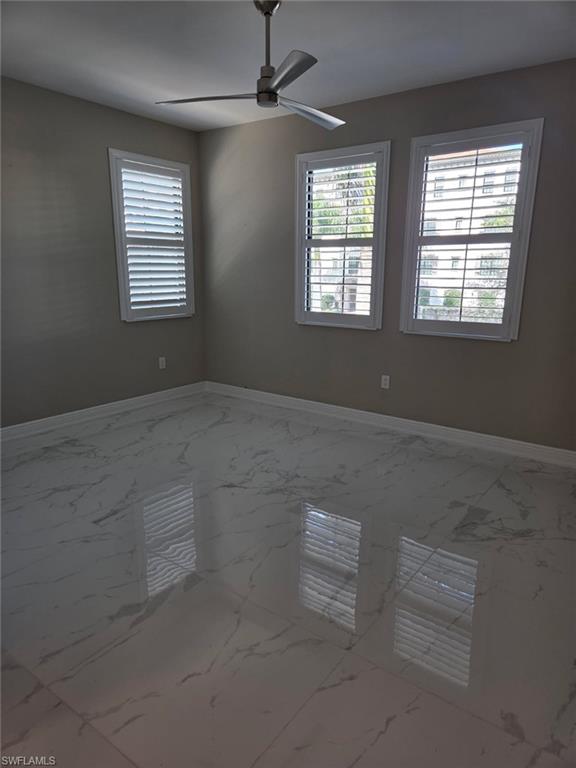 16370 Viansa Way, Unit 6 Naples, FL 34110 - Photo 8 of 27 Unfurnished room featuring marble finish flooring and ceiling fan