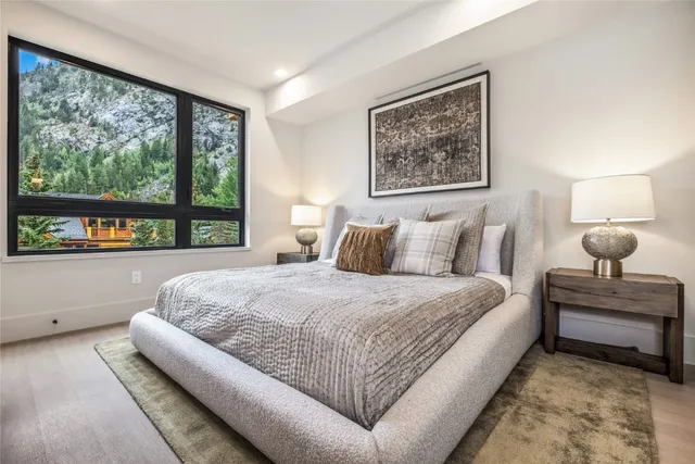 a bedroom with a large bed couch and window