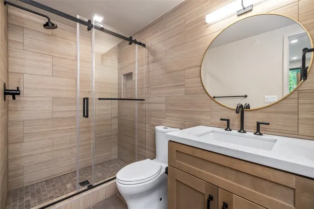 a bathroom with a sink toilet and shower