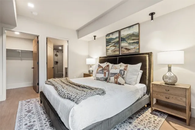 a bedroom with a bed and wooden floor