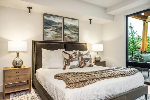 a bedroom with a large bed and a window