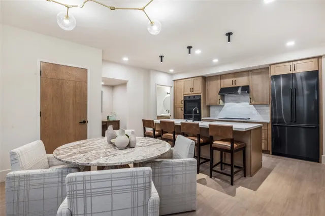 a kitchen with kitchen island granite countertop wooden cabinets and stainless steel appliances
