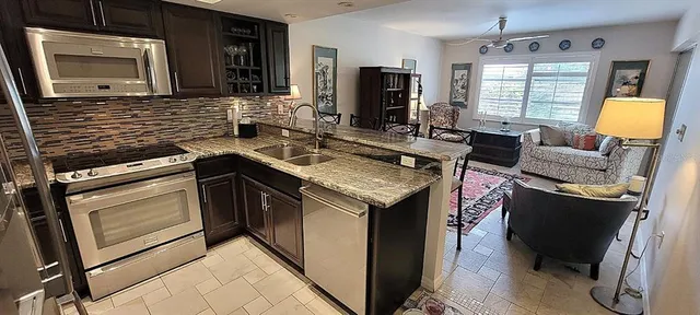 a kitchen with a stove sink and cabinets