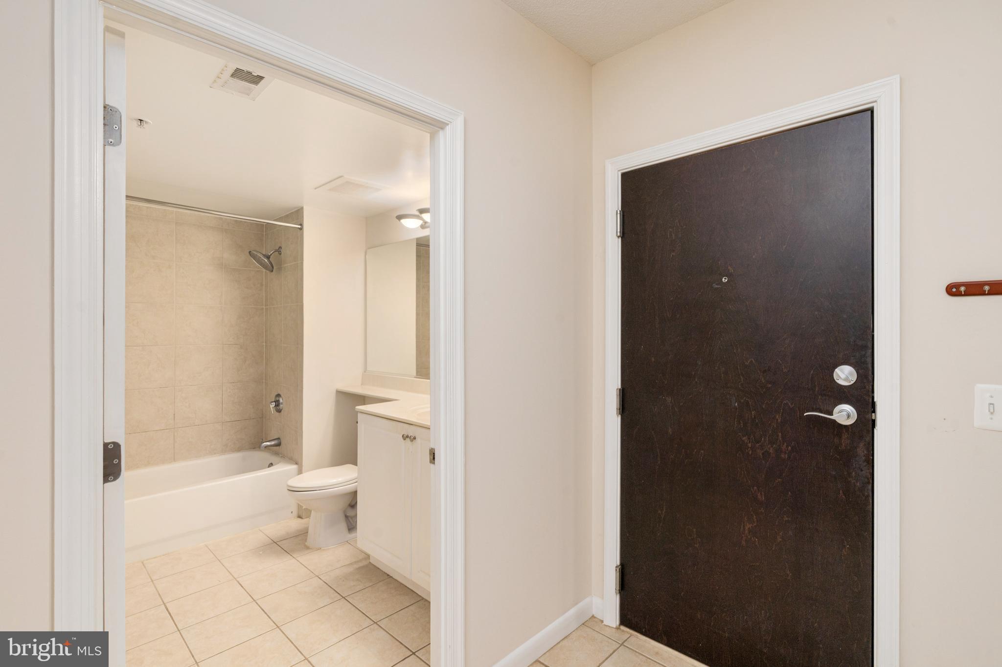 851 North Glebe Road, Unit 1407 Arlington, VA 22203 - Photo 17 of 51 a bathroom with a sink a toilet and shower