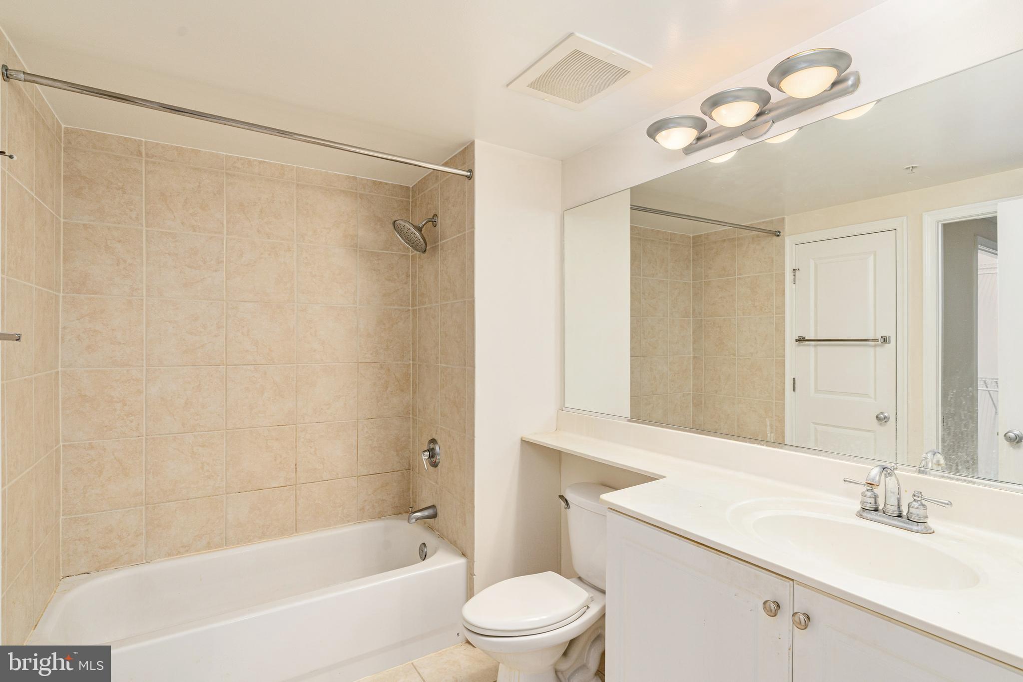 851 North Glebe Road, Unit 1407 Arlington, VA 22203 - Photo 19 of 51 a bathroom with a sink toilet and shower