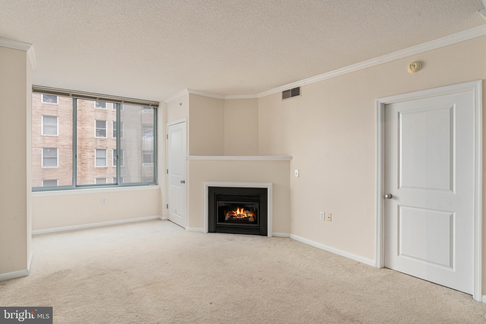 851 North Glebe Road, Unit 1407 Arlington, VA 22203 - Photo 24 of 51 a view of an empty room with a fireplace and a window