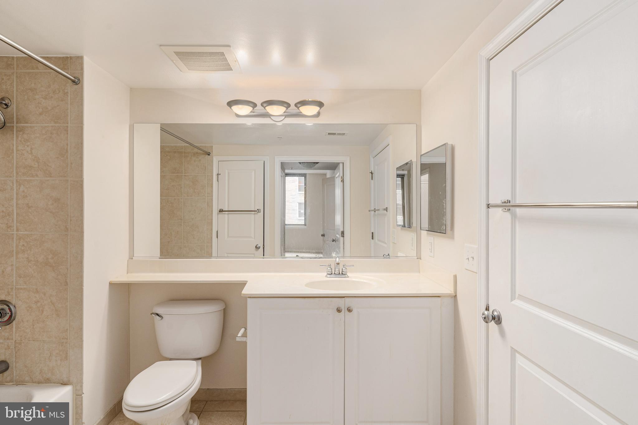 851 North Glebe Road, Unit 1407 Arlington, VA 22203 - Photo 37 of 51 a bathroom with a toilet sink and mirror