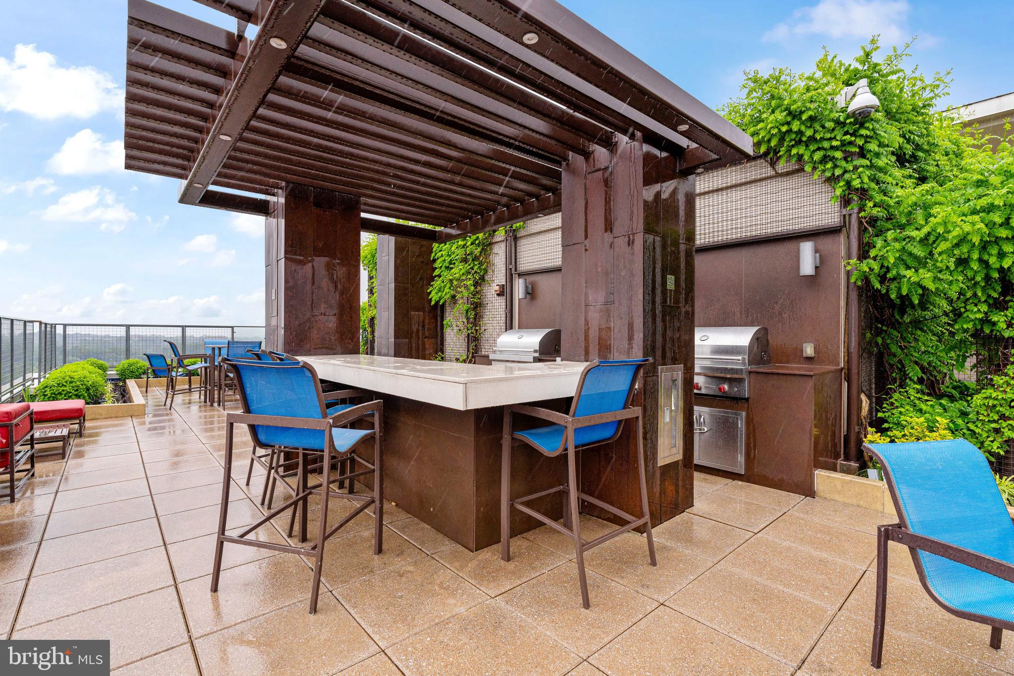 851 North Glebe Road, Unit 1407 Arlington, VA 22203 - Photo 43 of 51 a patio with a table and chairs and potted plants
