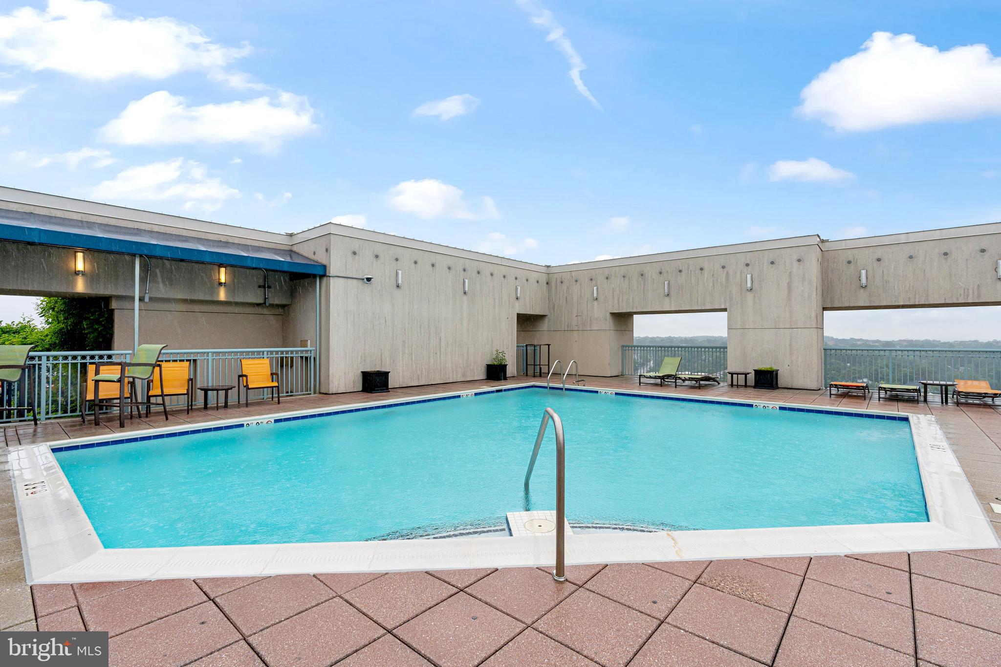 851 North Glebe Road, Unit 1407 Arlington, VA 22203 - Photo 47 of 51 a view of a kitchen with kitchen island and a view of living room
