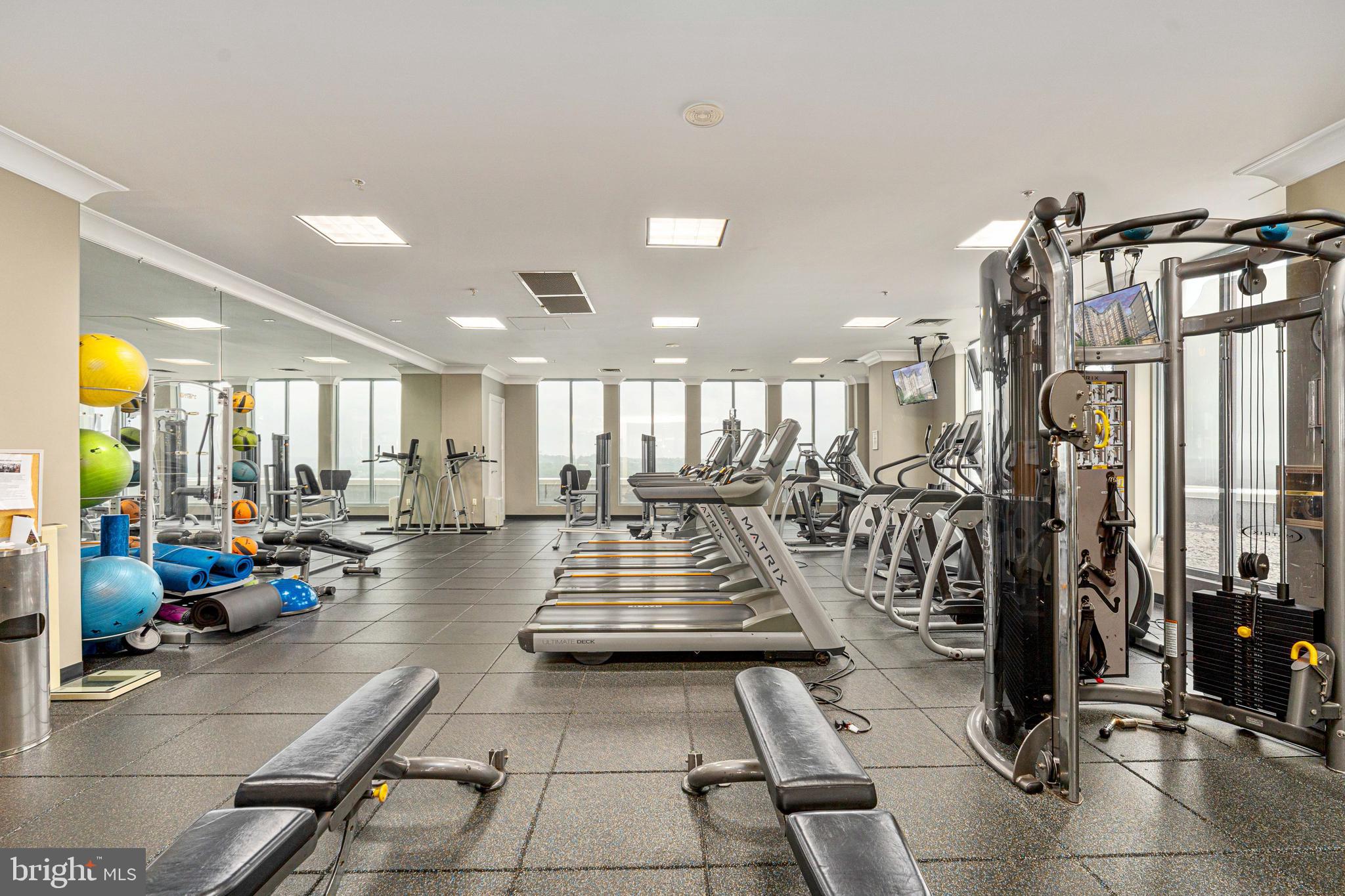 851 North Glebe Road, Unit 1407 Arlington, VA 22203 - Photo 9 of 51 a lobby with gym equipment and glass door